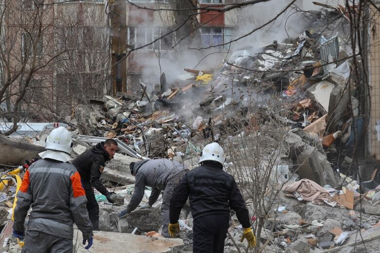 Rescuers are seen working in Odesa on Satudrday the aftermath of a Russian drone attack.