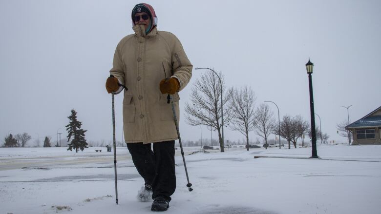 A man walking on a snowy road.