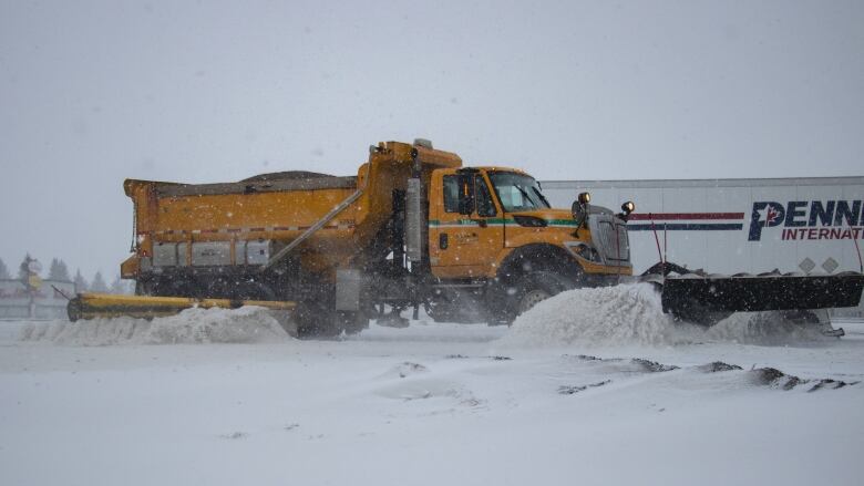 A snow plow under heavy snow.