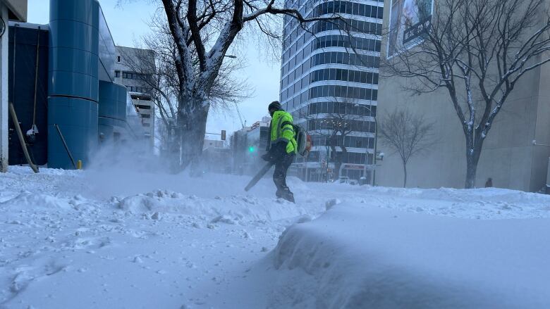 Man blowing snow on the street