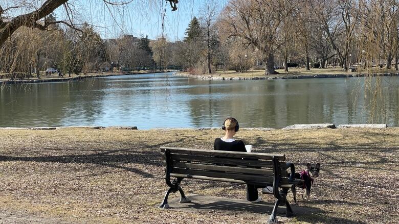 a woman on a bench with a dog