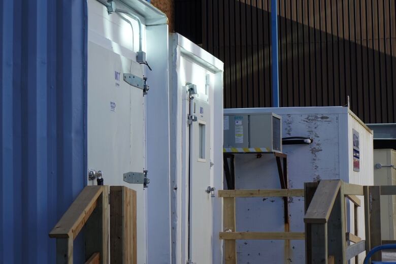 White and blue storage containers with wooden railings. 