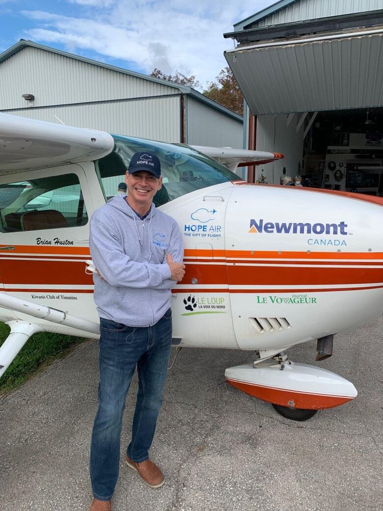 Man standing in front of a small plane.