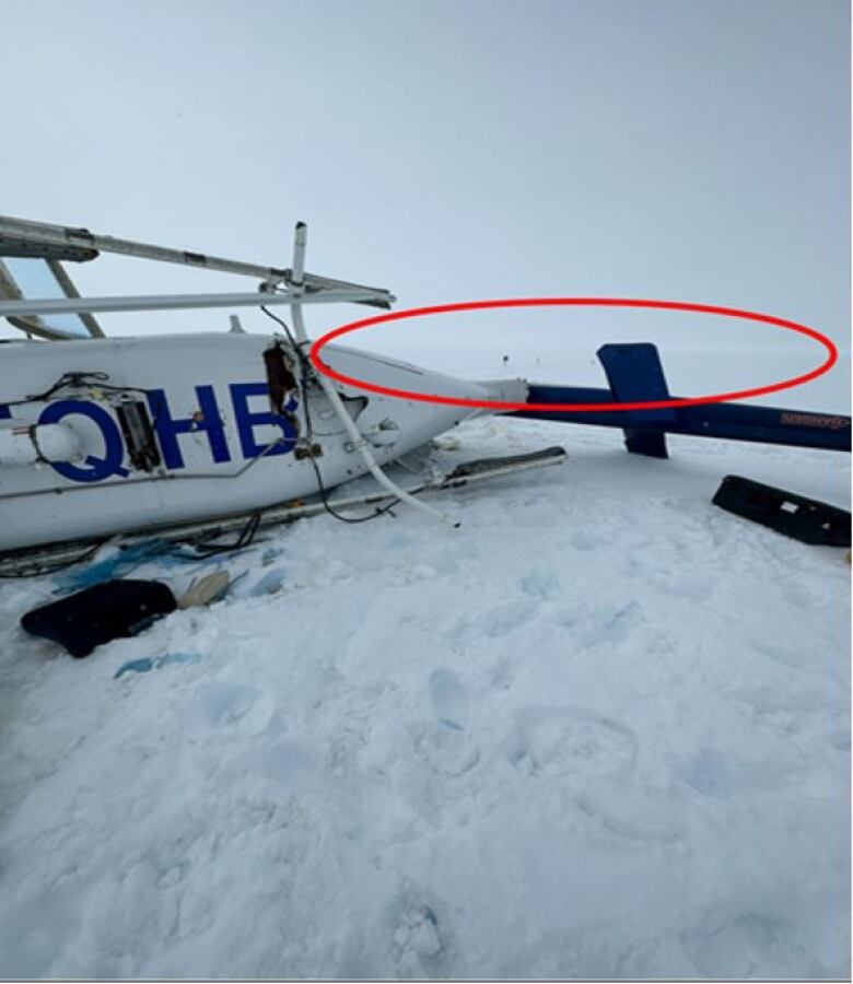 A helicopter after it has crashed, with a red circle showing the flat light conditions that day. 