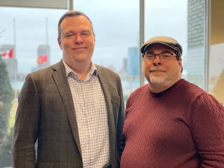 David Cote, left, is with legal assistance of Windsor, Ont. Mike Morency is the executive director of a refugee centre in Windsor called Matthew House. 