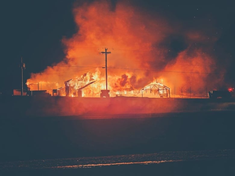 A fire engulfs the Covered Bridge Potato Chip plant.