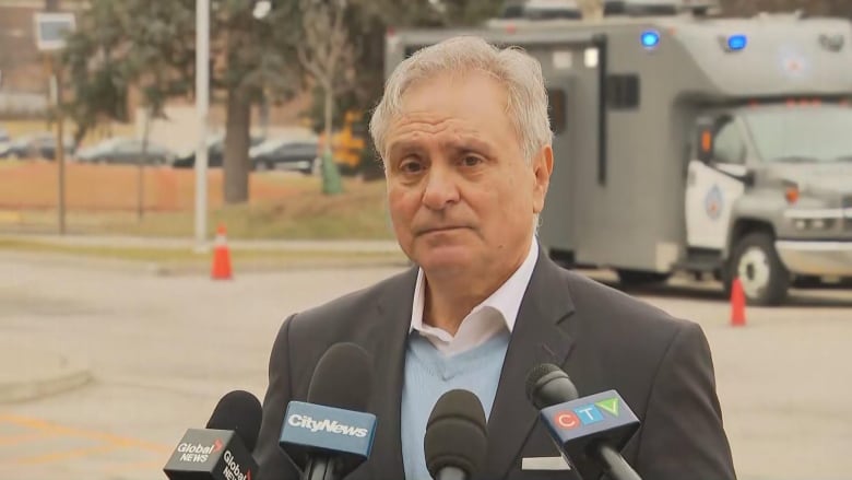 A manspeaks at a press conference.