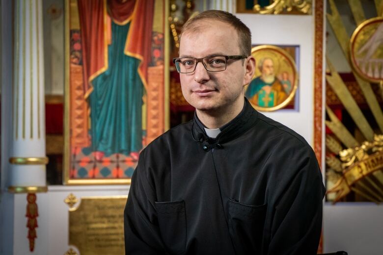 A man stands in a church. 