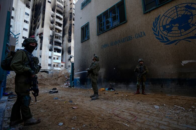 Israeli soldiers take position near the UNRWA headquarters in Gaza, Thursday, Feb. 8, 2024.