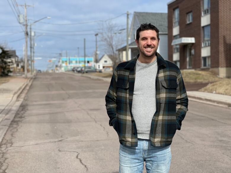 man standing in street smiling