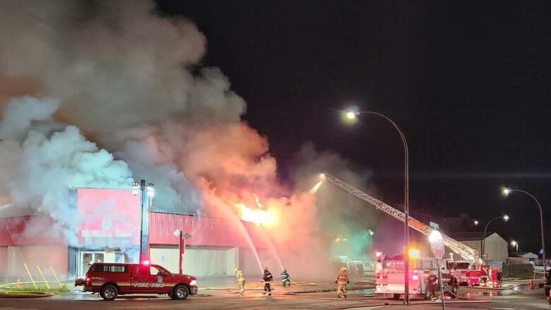 Firefighters fight a mall on fire.