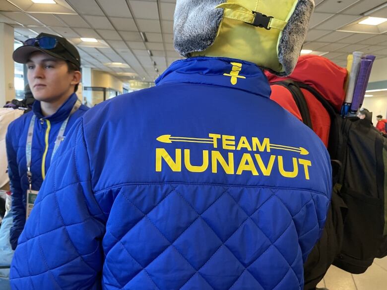 The back of a blue and yellow jacket that says team Nunavut