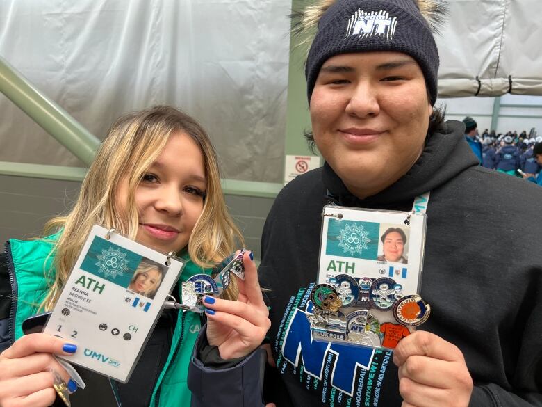 Young women holding up collectible pins