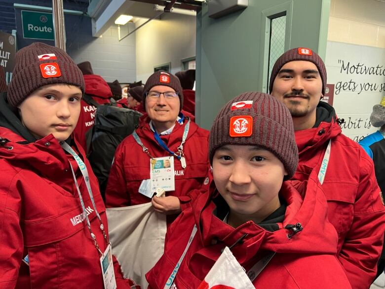 Four people in red jackets