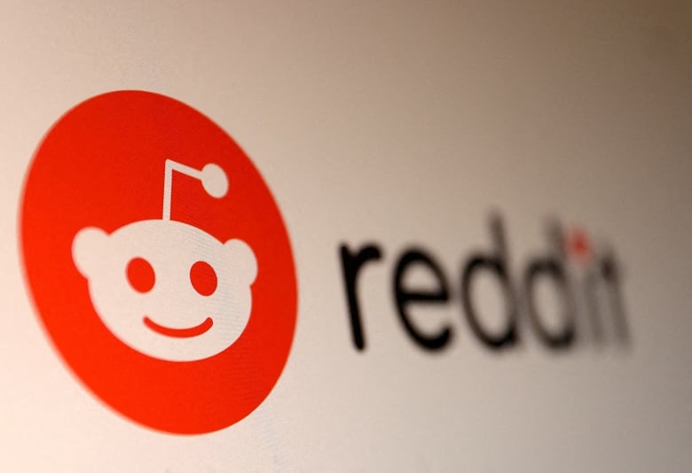 A logo of a small alien in a red circle appears next to the word Reddit. 