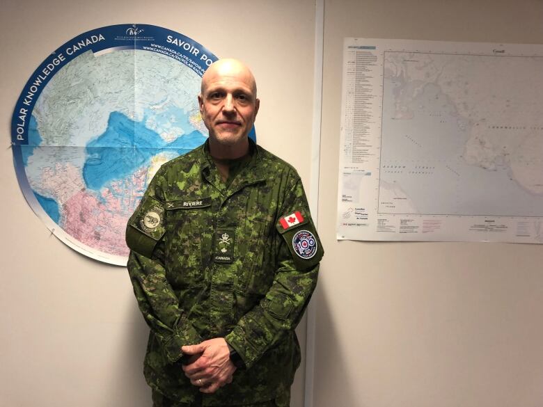 A man poses in front of a map.