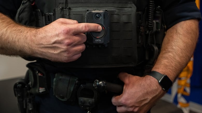 A police officer with a body camera on.