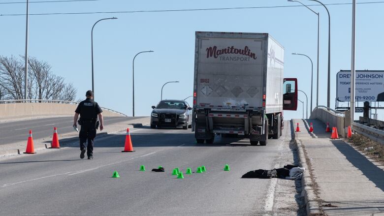 Police in London block off Adelaide Street North to investigate a fatal crash involving a pedestrian and a transport truck. 