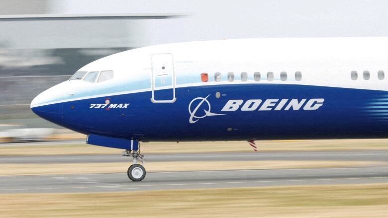 A Boeing plane is shown taxiing on a runway.