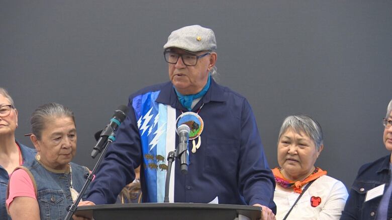 A man talking from behind a podium