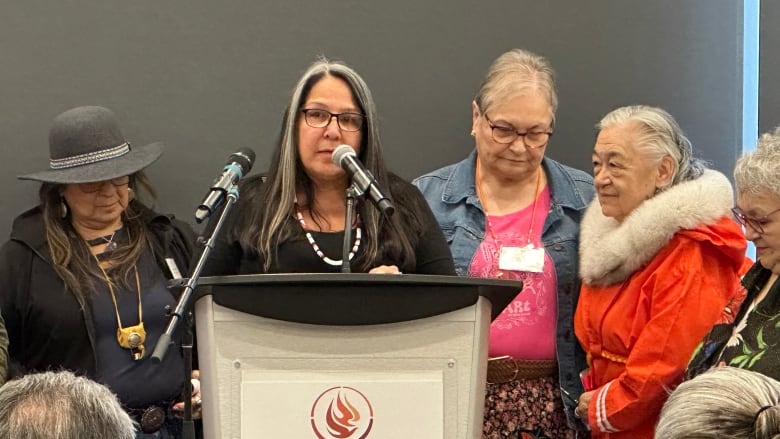 A woman speaking from behind a podium