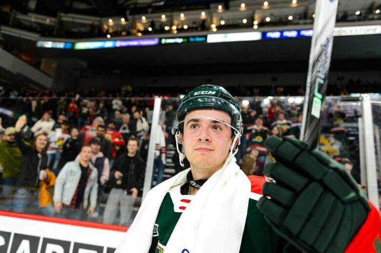 A hockey player smiles