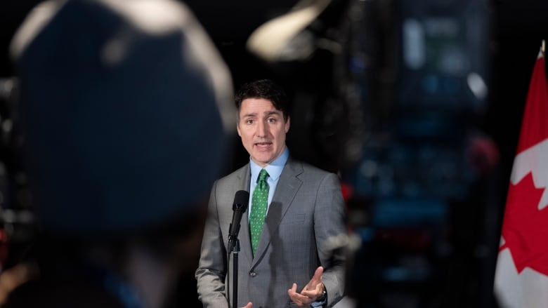 man speaking at microphone