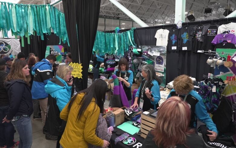 Many people at merch table for arctic winter games