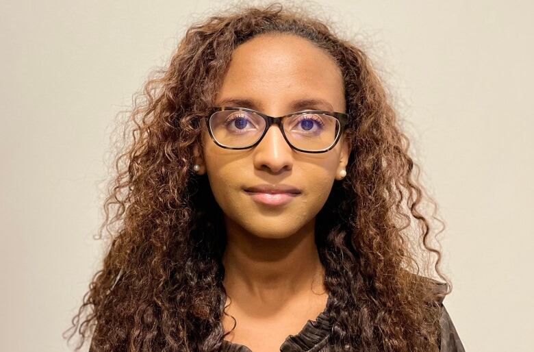 A woman smiles at the camera.