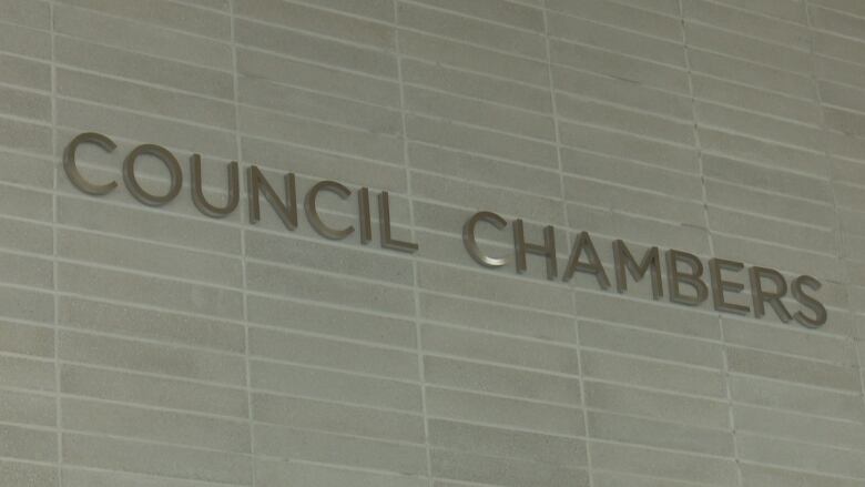 A sign reading 'Council Chambers.'