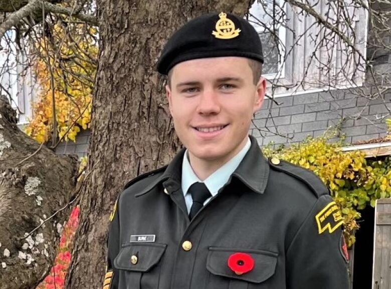 Harry Burke in reserves uniform, wearing a poppy.