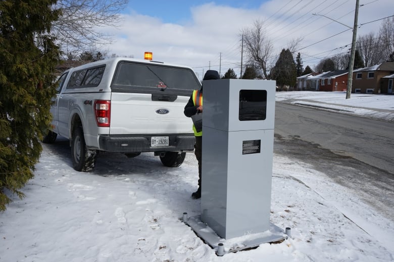 A large boxy camera on the side of a road.