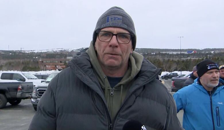 A man in a toque and winter jacket.