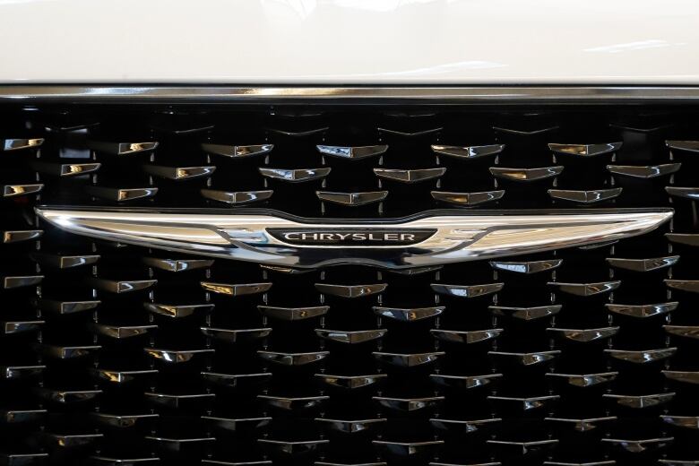 The Chrysler logo is displayed on the front grill of a car.