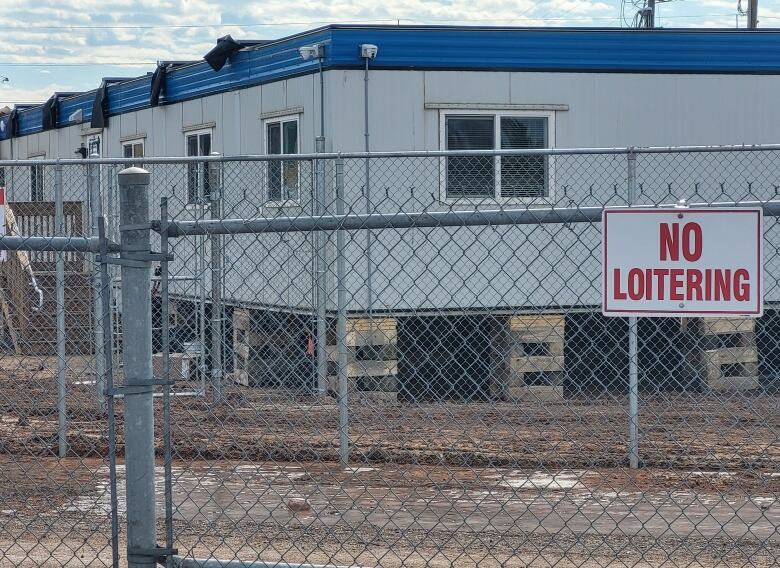 The new Community Outreach Centre location on Park Street behind a chain link fence with a No loitering sign.