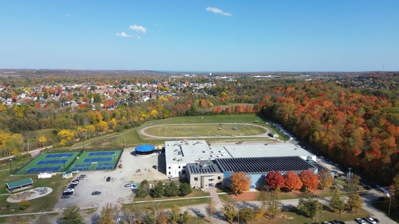 A recreation facility in a small town, with tennis courts and a track.