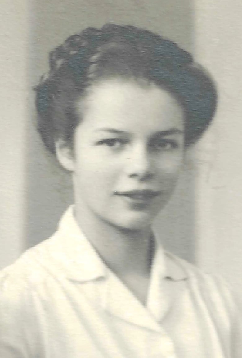 A black and white head shot of a young woman. 