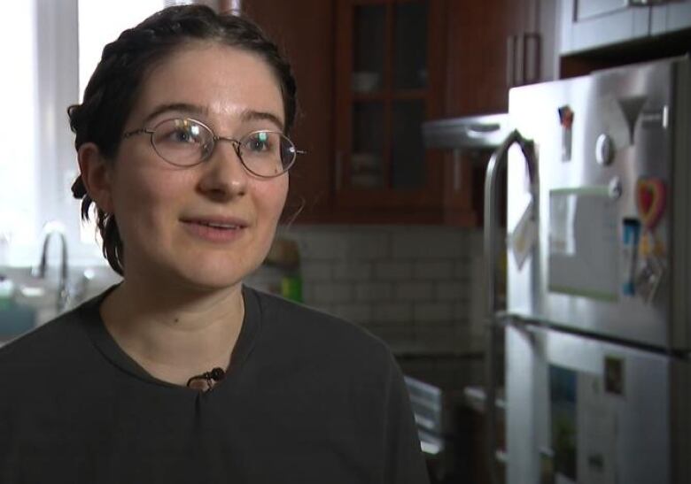 McLaughlin wears glasses with her hair pulled back. She stands in the kitchen of her home.