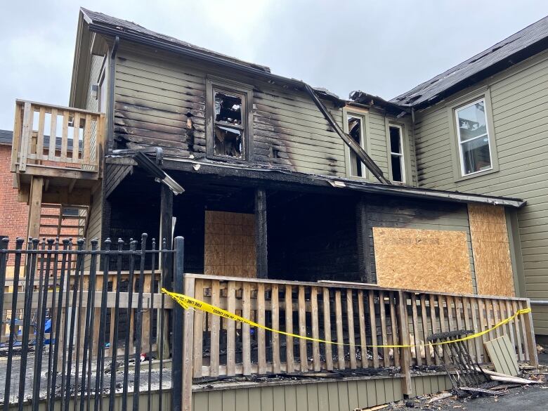 A wooden building damaged by fire.