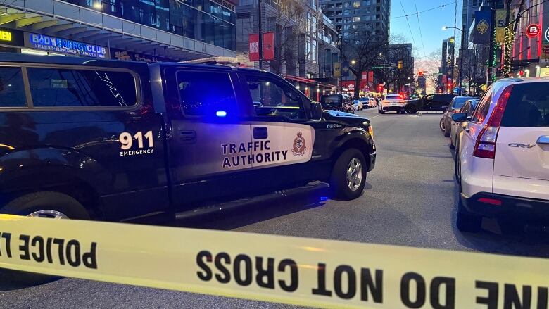 Police tape cordons off a stretch of Robson Street as police investigate.