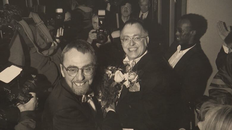 two men smiling at their wedding