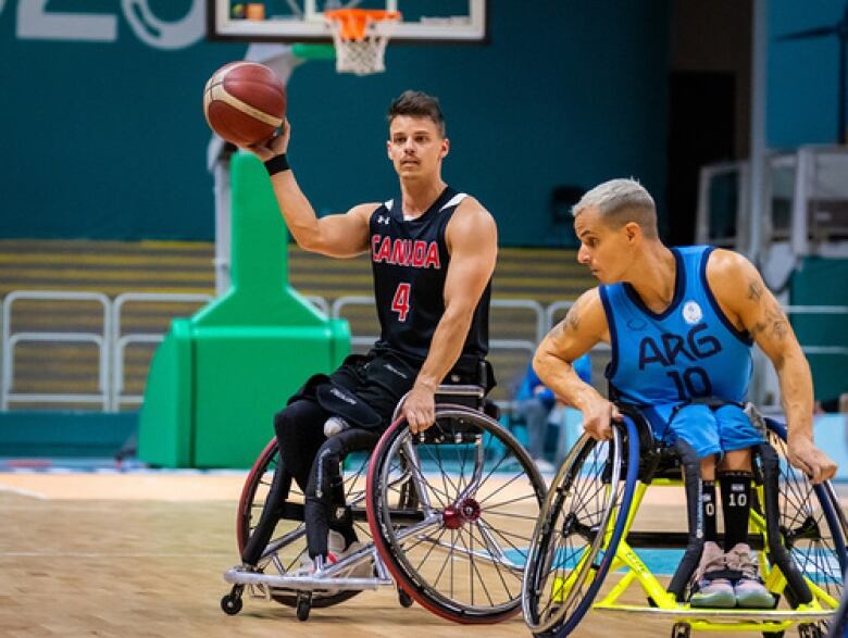 A man in a black Canada jersey and another in a blu Argentina jersey compete in wheelchair basketball.