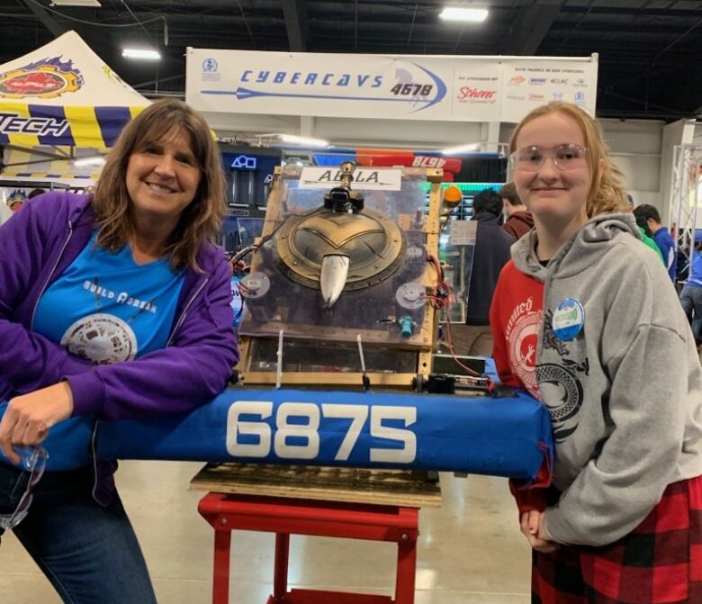 Cherie Sulyak, left, and Grace Foreman belong to the Amazon Warriors robotics team from the Windsor-area. Sulyak is a lead mentor and Foreman is a team member.