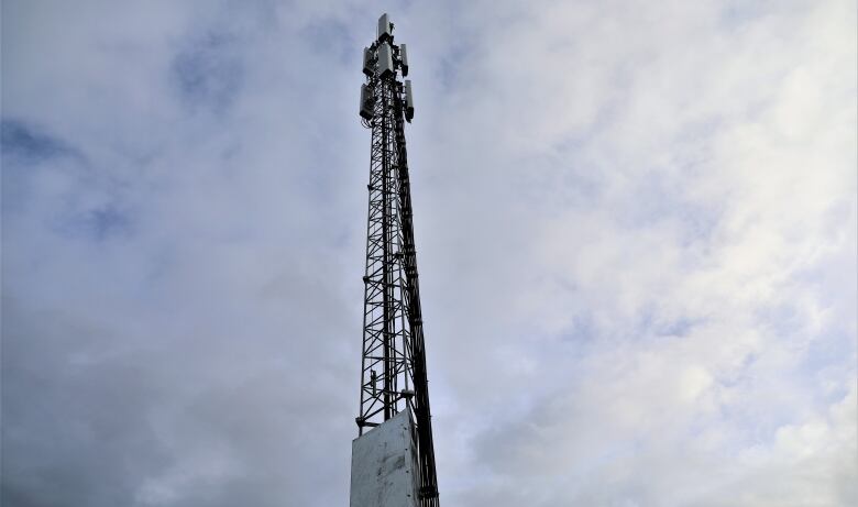 A cellphone tower is seen against a blue sky.