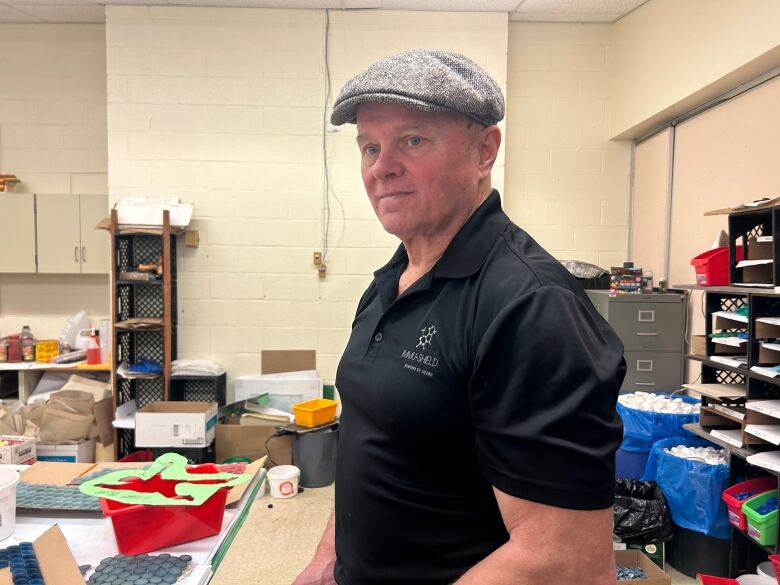 Man in black shirt and hat.