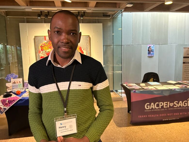 Man stands in front of GACPEI booth.