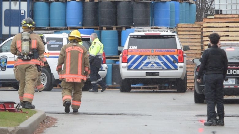 Firefighters, paramedics and police outside of a warehouse.