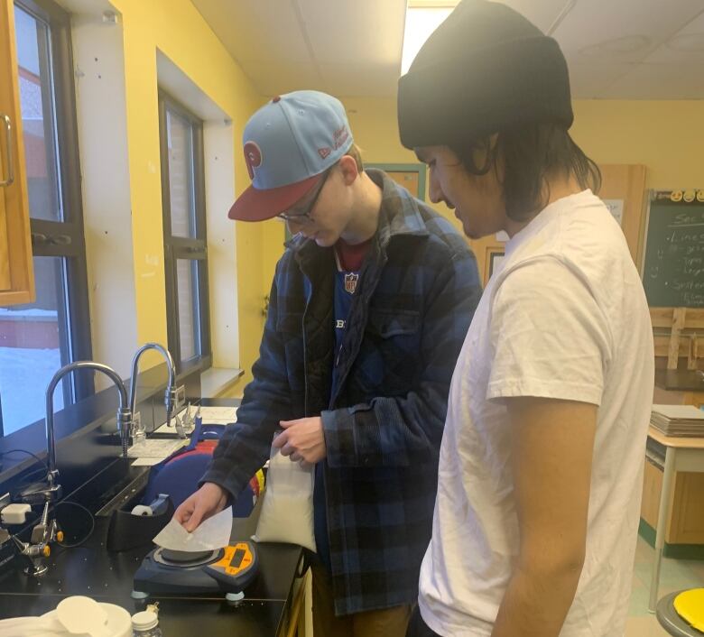 Two teenage boys working in a school lab.