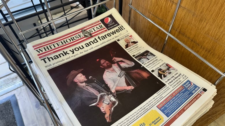 A newspaper sitting in a rack. 