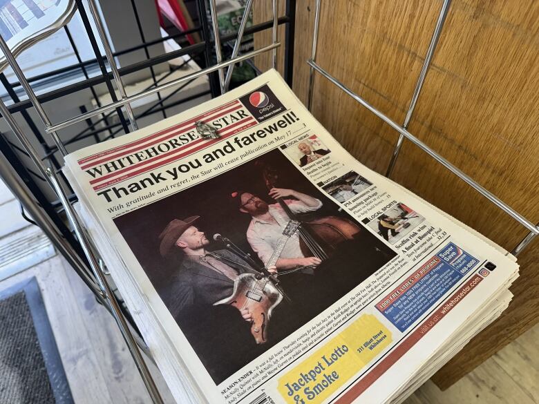 A newspaper sitting in a rack. 